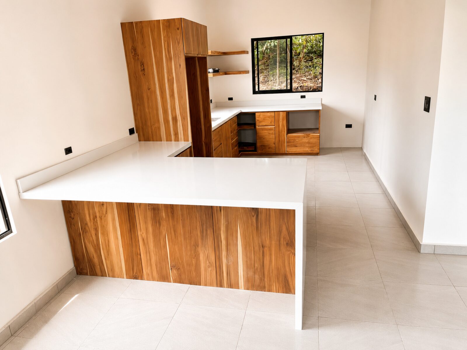 Custom white countertop with natural wood cabinetry in a Guanacaste kitchen.