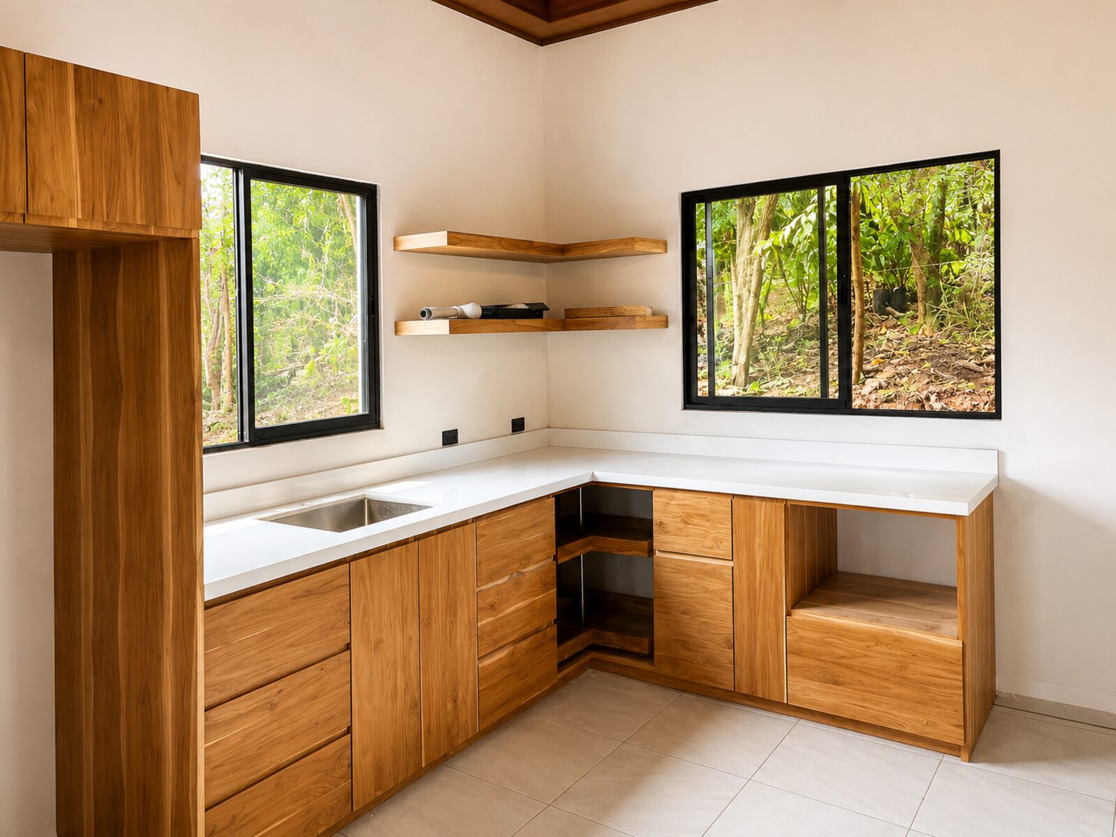 White kitchen countertop with custom wood cabinetry and sink installation in Guanacaste.