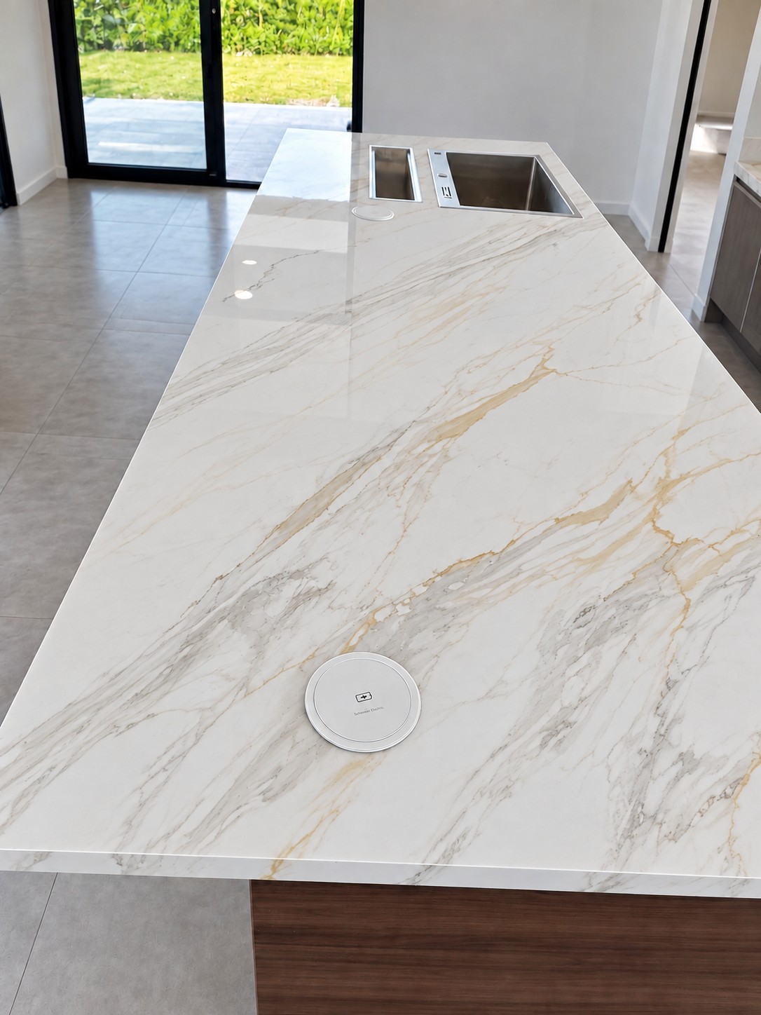 Modern kitchen with a light porcelain countertop and wood cabinetry, view 2